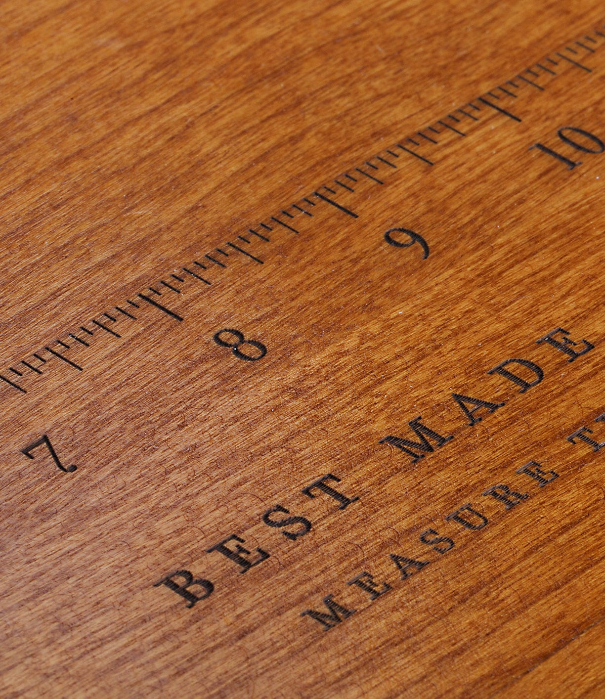 A close-up of a wooden ruler with black markings, showing numbers 7 to 10, rests on a Best Made Co. 41D Gerstner Chest 2026. "BEST MADE" is partially visible below the ruler's marks.