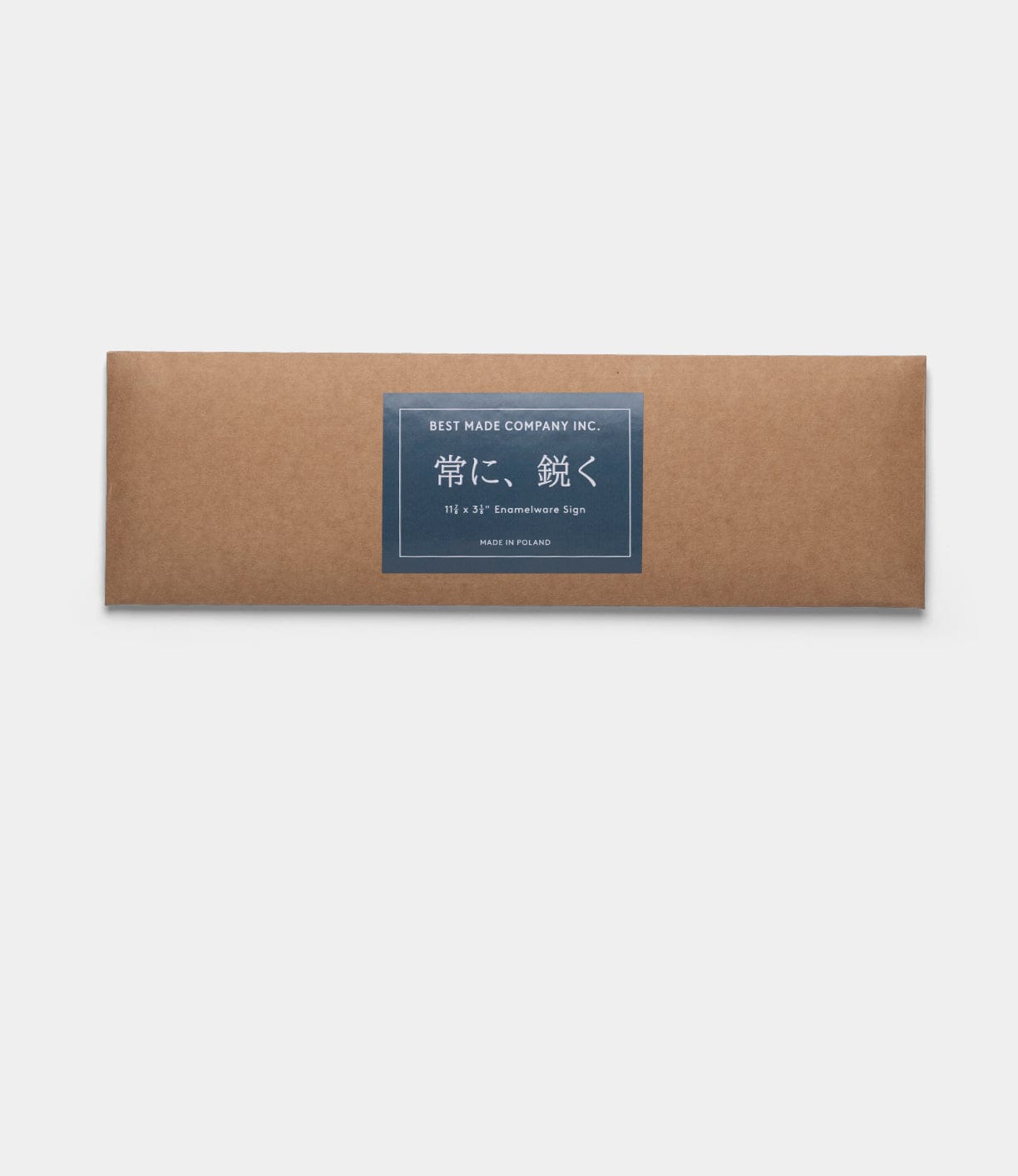A rectangular brown box with a dark blue label reading “Best Made Co.” features Japanese text, suggesting handcrafted quality. Inside is the “Stay Sharp” Enamel Steel Sign (Kanji Edition), set against a plain white background.