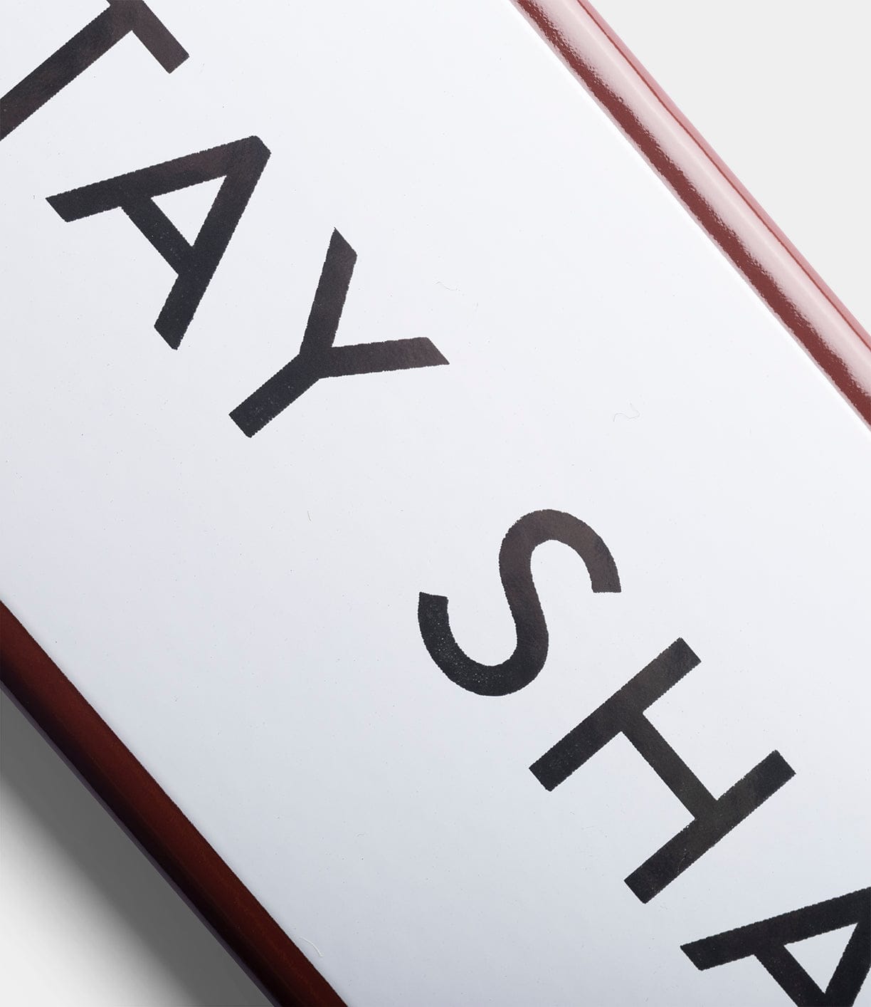 A close-up of the Best Made Co. “Stay Sharp” durable white enamel steel sign with bold black lettering and a red border, set against a gray background.