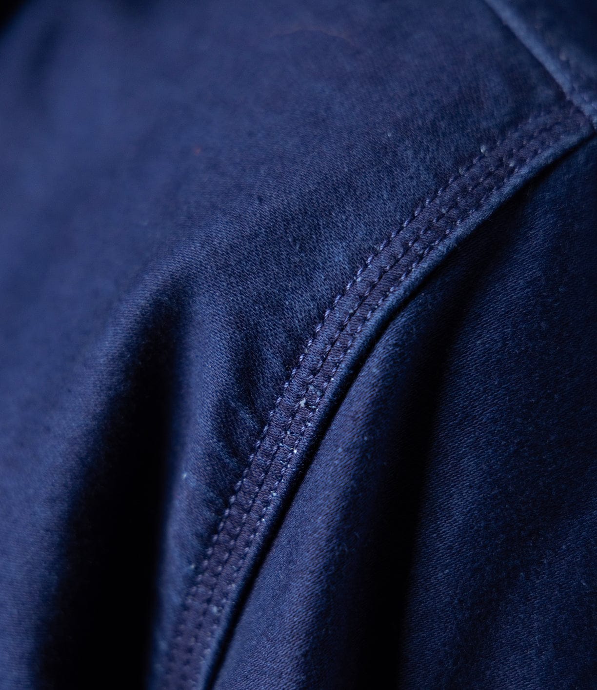 Close-up of a seam on the Best Made Co Indigo Moleskin Work Shirt, highlighting detailed stitching, soft smooth texture, and high-density weave.