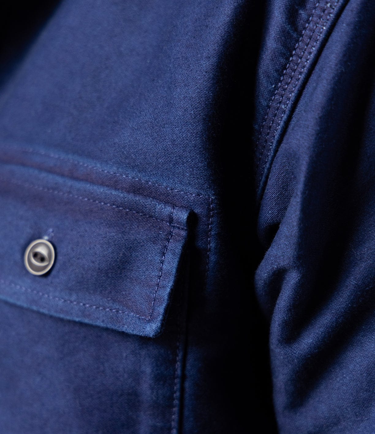 Close-up of Best Made Co's Indigo Moleskin Work Shirt, featuring high-density moleskin, a flap pocket with metallic button, and visible triple-needle stitching.