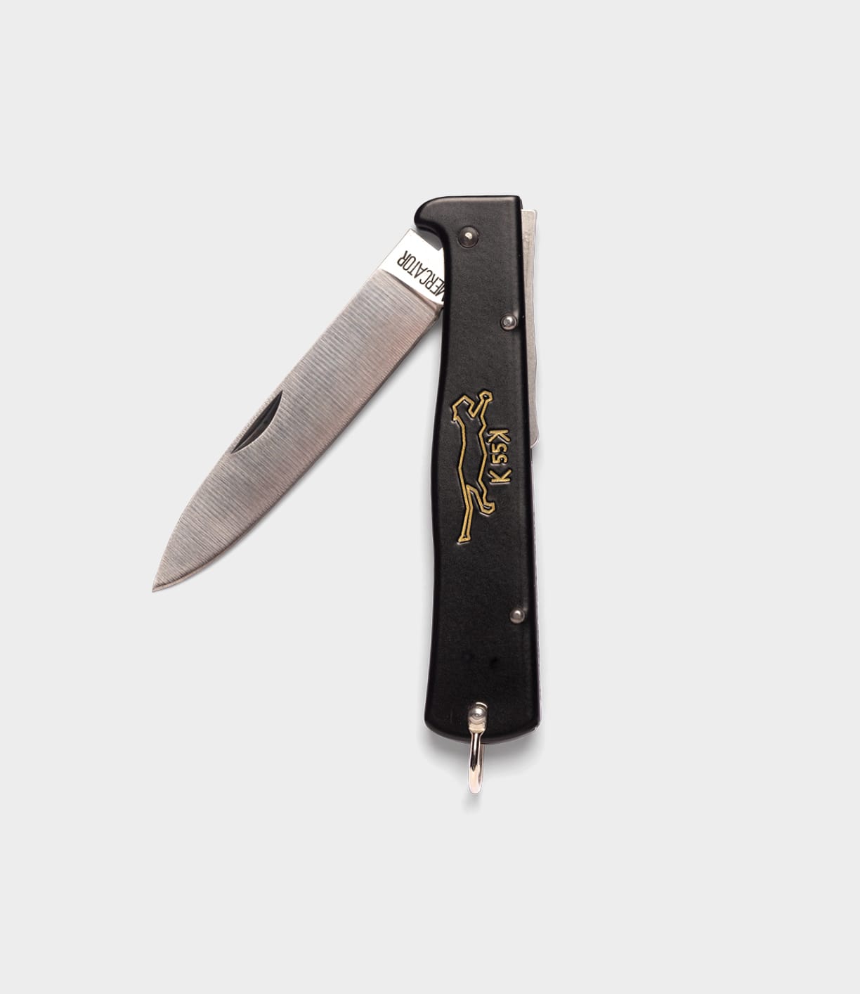The Best Made Co. K55K Mercator is a black folding pocket knife with a partially open carbon steel blade and gold engraving of a leaping animal and "KISS" on the handle, shown against a plain white background.