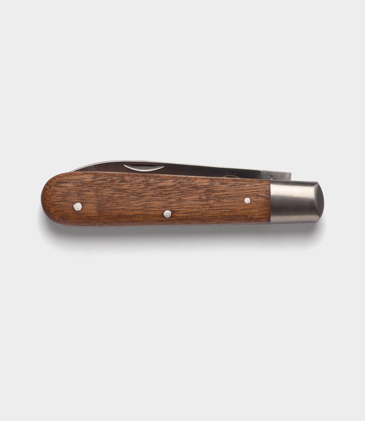 A closed Best Made Co. Otter-Messer Pocket Knife with a sapele handle, silver metal ends, and a carbon steel blade is shown on a plain light gray background.