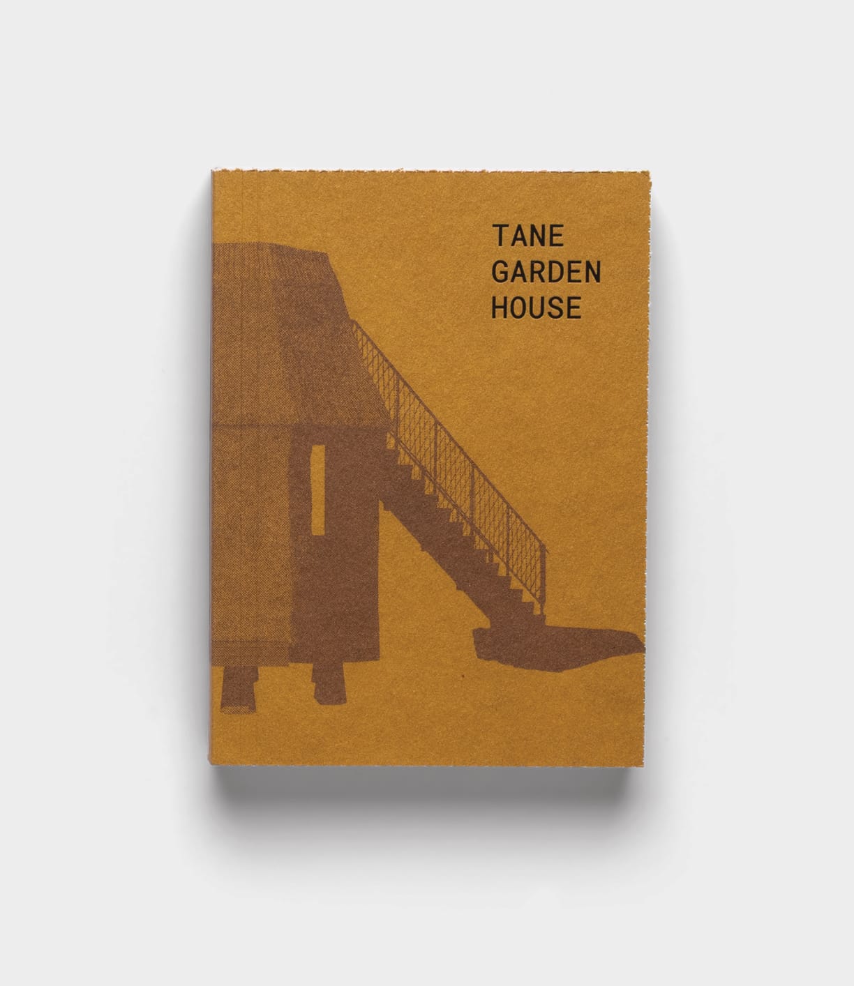 Tane Garden House by Best Made Co. is a brown book featuring a minimalist building with a staircase on its cover, set against a plain white background.