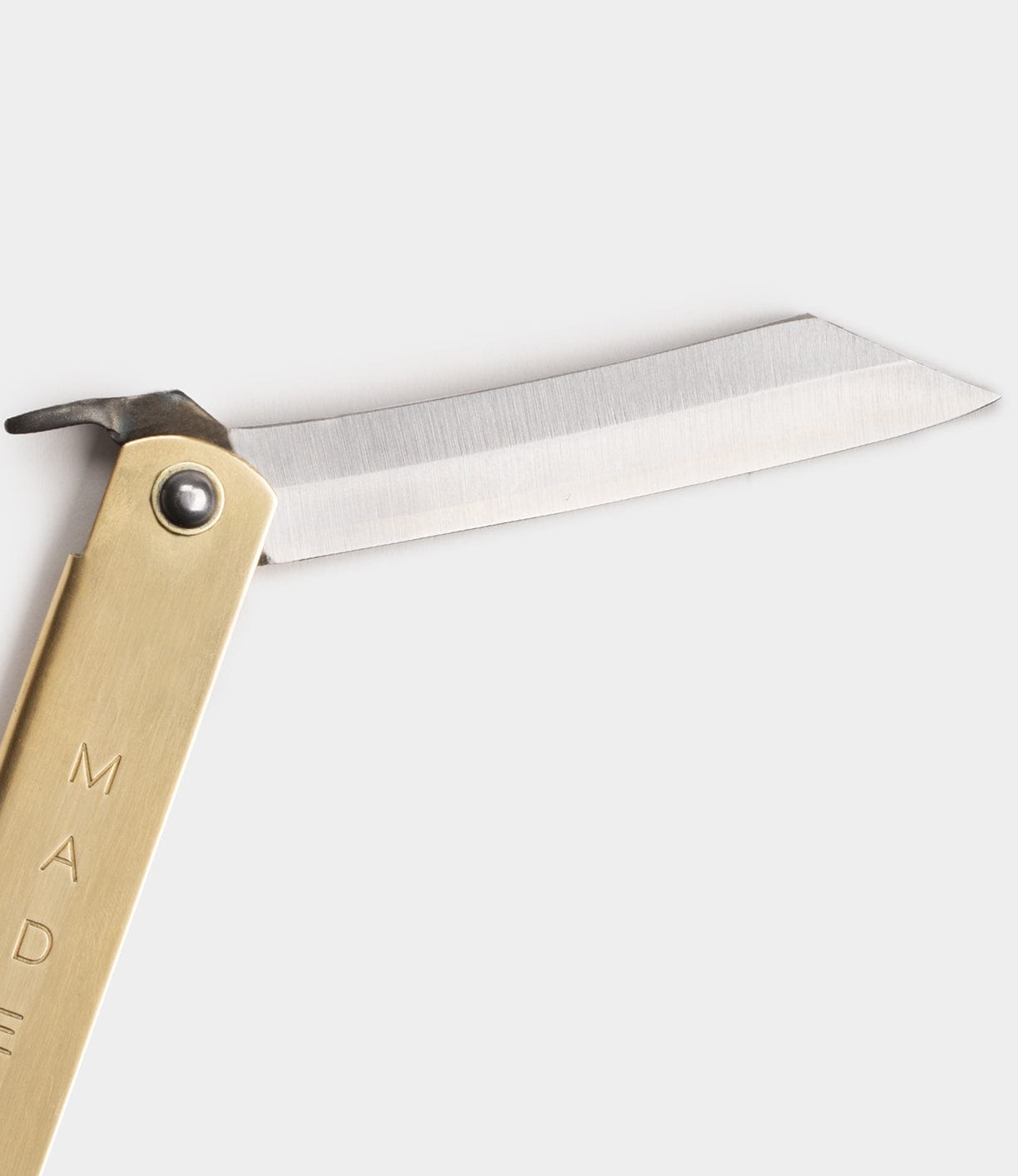 The Max Brass Higo Knife by Best Made Co, featuring a brass handle and straight-edged stainless steel blade, is shown against a plain white background.