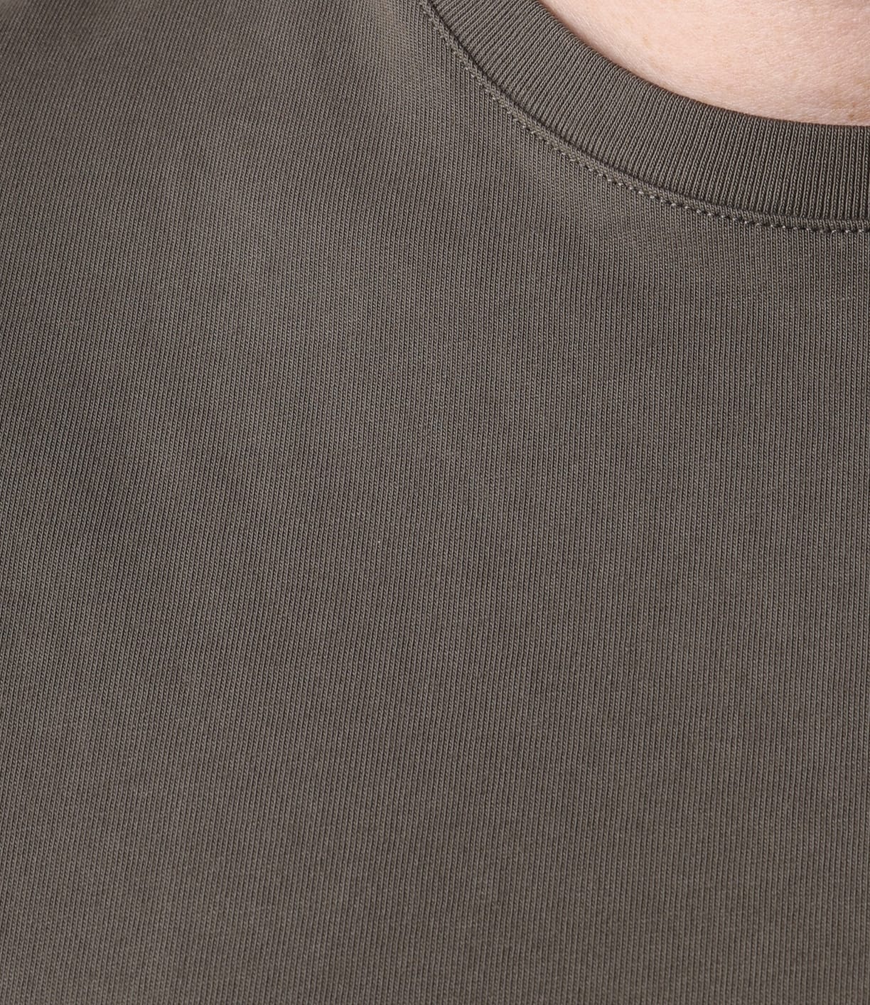 Close-up of a person wearing the Best Made Co Standard T-Shirt Field Drab, featuring a plain olive crew-neck design. The garment-dyed Peruvian tangüis cotton looks soft, slightly textured, and durable.