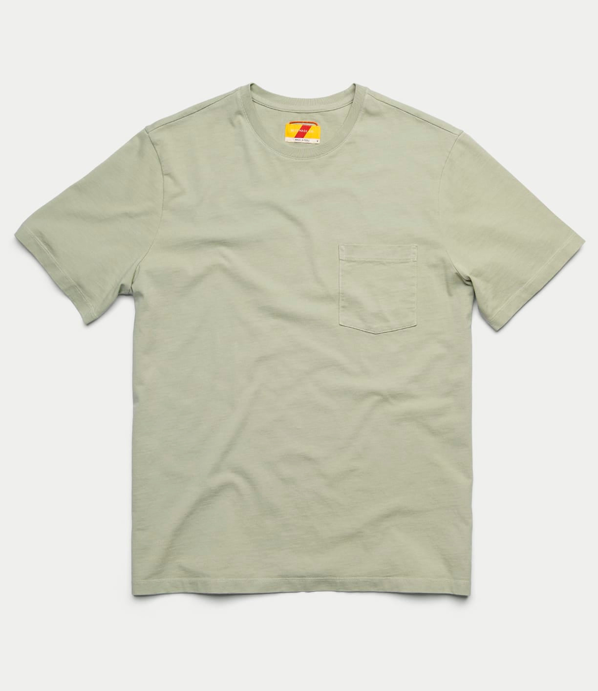 The Best Made Co Standard Pocket T-Shirt Haze is a light green, garment-dyed Peruvian tangüis cotton tee with short sleeves, a round neckline, and a small chest pocket on the left, shown flat on a plain white background.