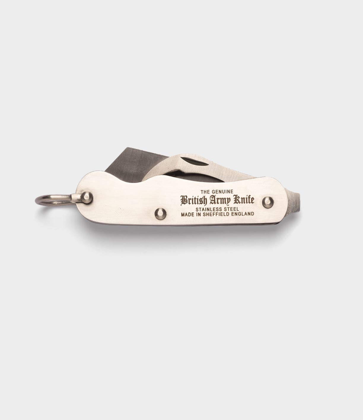 A closed Best Made Co. British Army Knife, made of stainless steel and engraved with "THE GENUINE British Army Knife STAINLESS STEEL MADE IN SHEFFIELD ENGLAND," rests on a light gray background.
