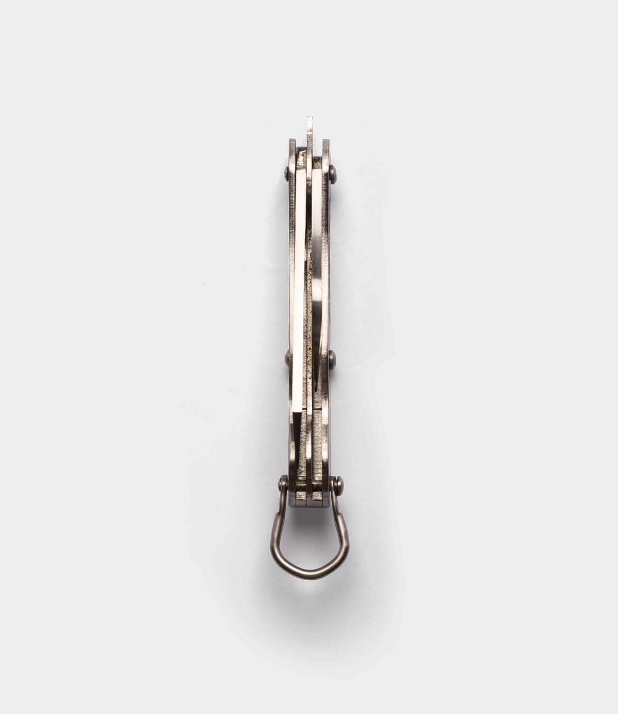 A Best Made Co. British Army Knife is shown from above with its metal frame, hinge, and closed blade visible against a plain light gray background.