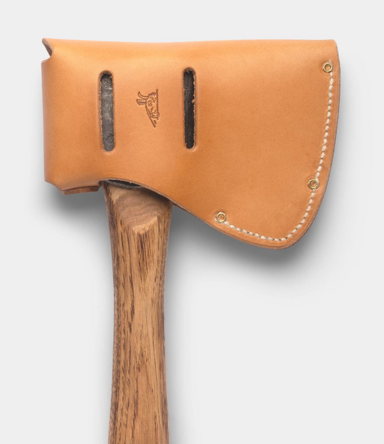 The Spark (Straight-Hold Edition) by Best Made Co. features an Appalachian hickory handle and a high-carbon steel blade, protected by a tan leather sheath with white stitching, metal rivets, and a stamped small animal logo.