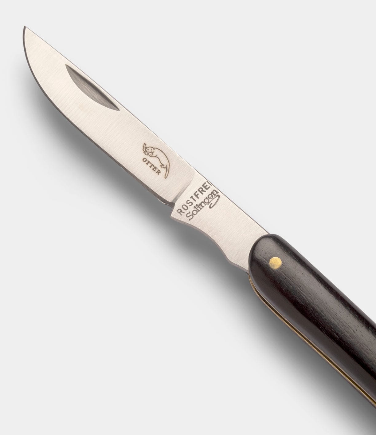 A partially open Little Doctor Knife by Best Made Co, featuring a stainless steel blade with engraved text and fish logo, black handle, and brass rivets, is displayed on a plain light gray background—an ideal everyday folder.