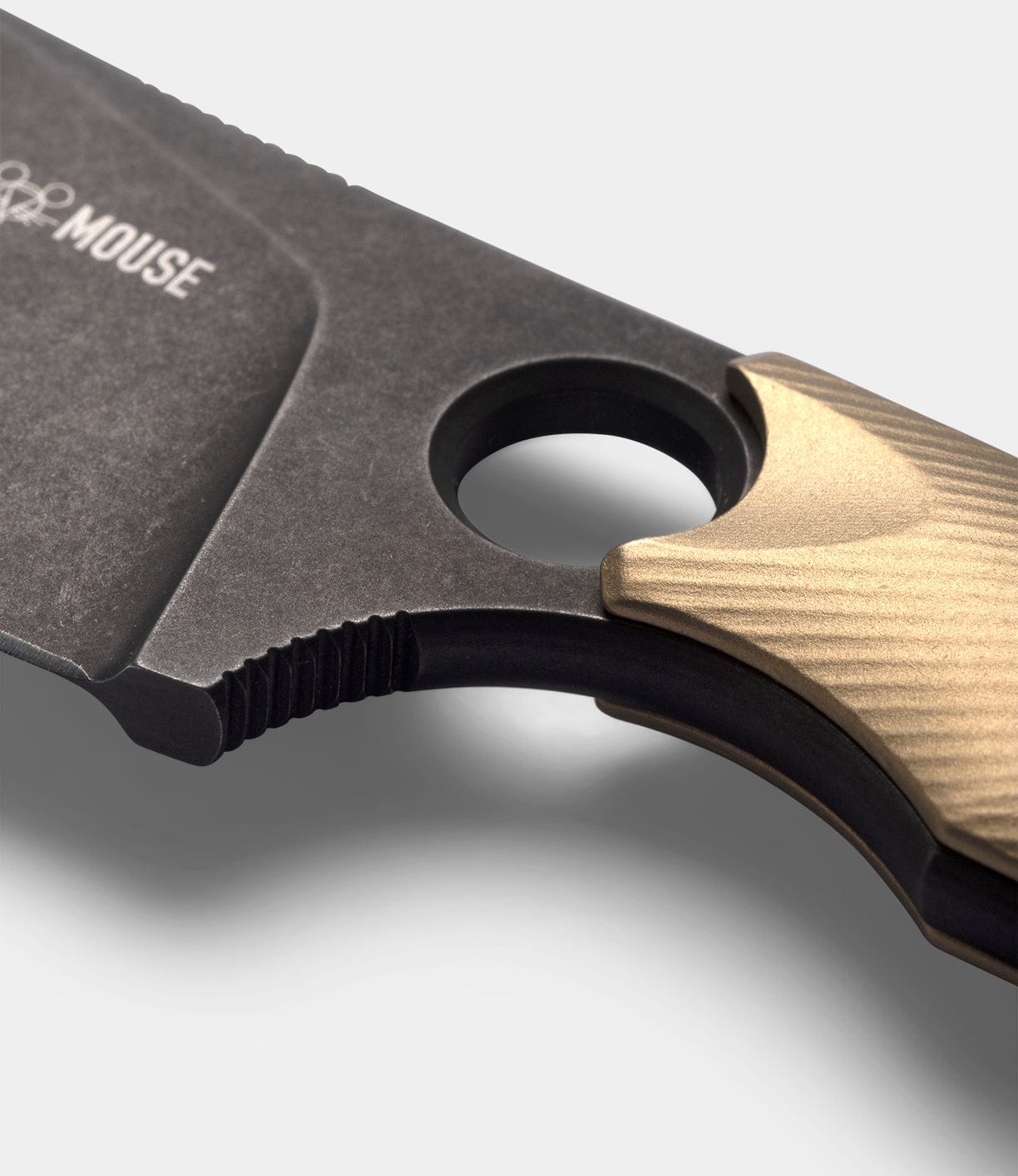 Close-up of the Best Made Co GiantMouse GMF1-P (BMC Edition) fixed blade, featuring a textured metallic grip, finger hole by the blade, dark matte finish, and premium N690 steel construction.