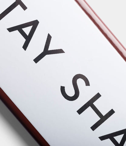 A close-up of the Best Made Co. “Stay Sharp” durable white enamel steel sign with bold black lettering and a red border, set against a gray background.