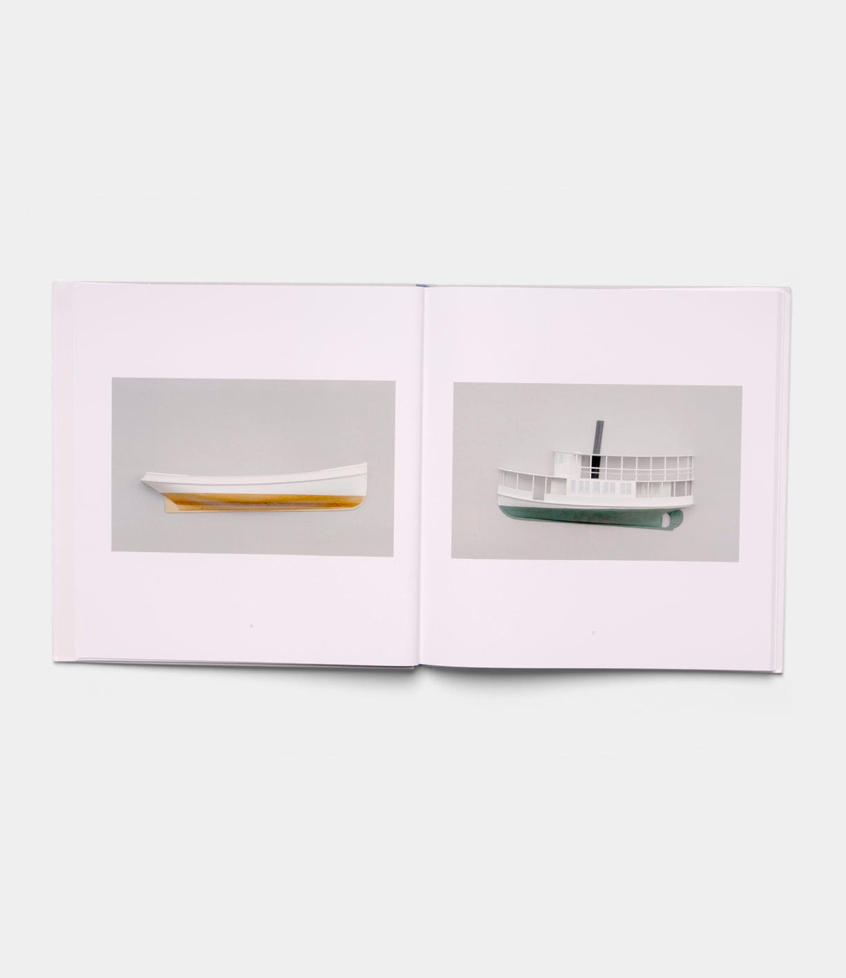 An open book from Best Made Co.'s "Boats, Books, Birds" displays two pages: the left features a minimalist white and yellow boat model, while the right shows a white steamboat model, each set against a plain background.