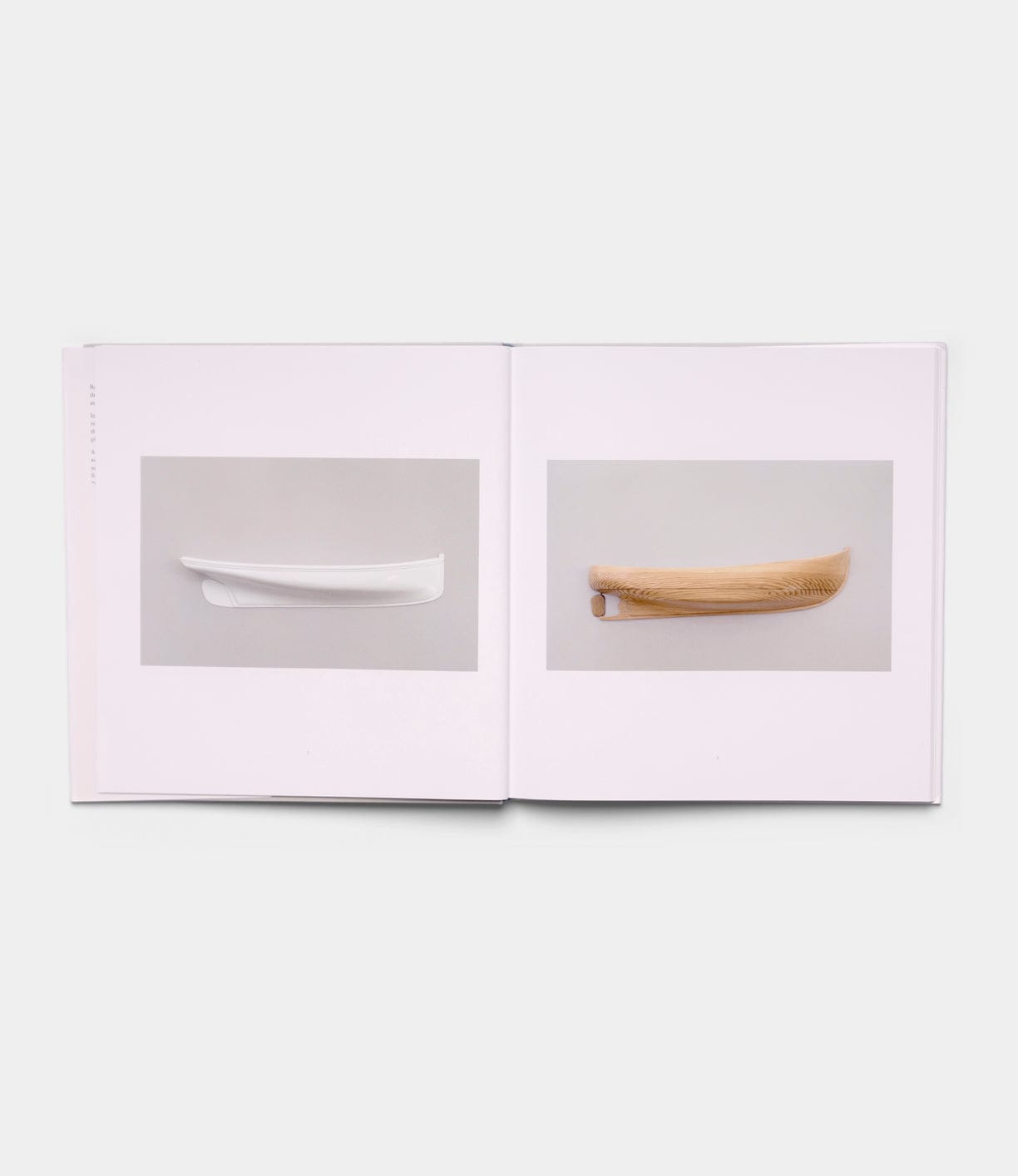 An open book from Best Made Co.’s "Boats, Books, Birds" shows two pages: one with a centered photo of a white minimalist object, the other featuring a light brown curved wooden object set against a neutral background.