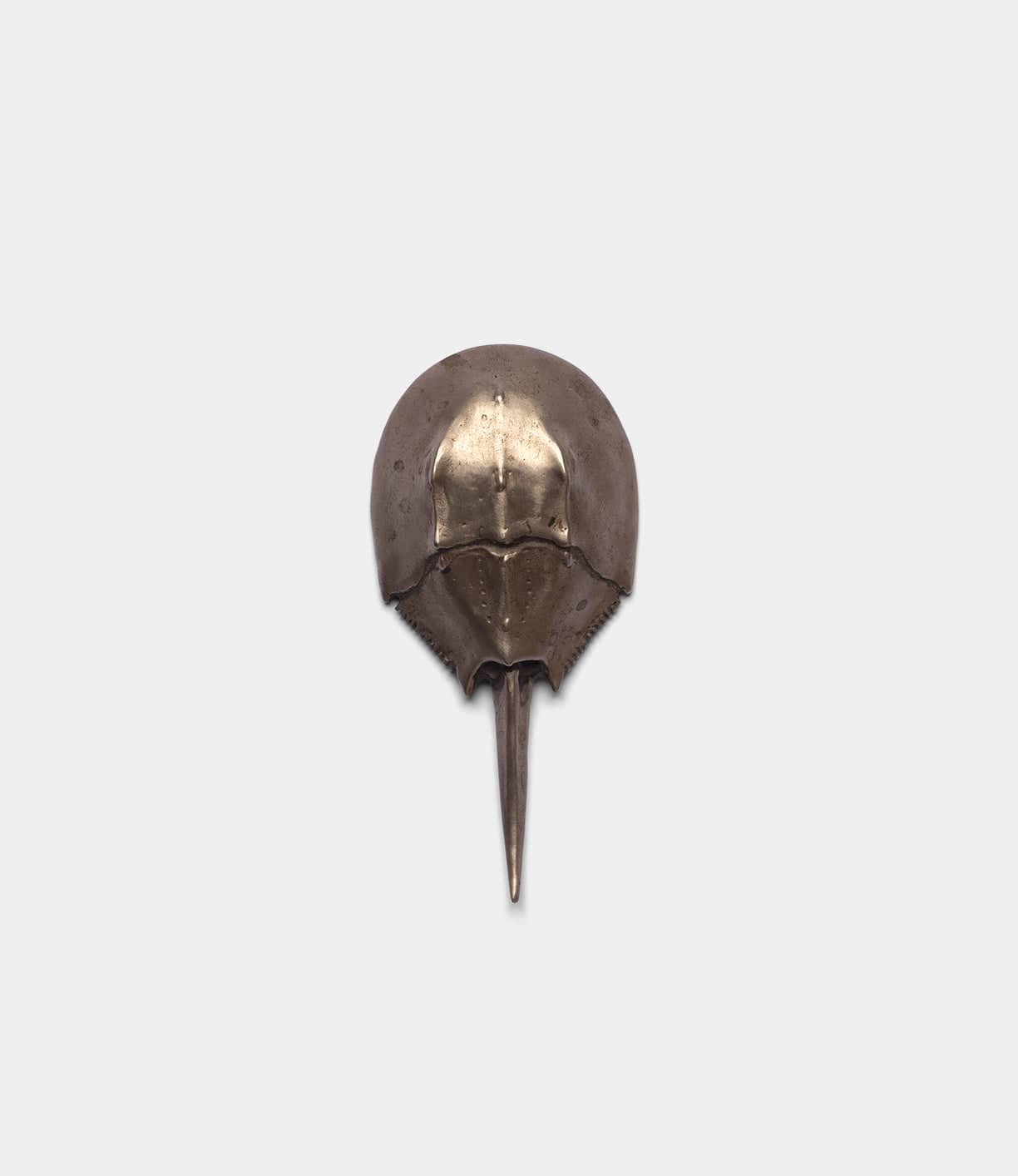 The Best Made Co. Horseshoe Crab Opener is a sculptural bottle opener with a rounded, domed shell and pointed tail, crafted using lost wax casting for intricate detail. Shown against a plain light background.