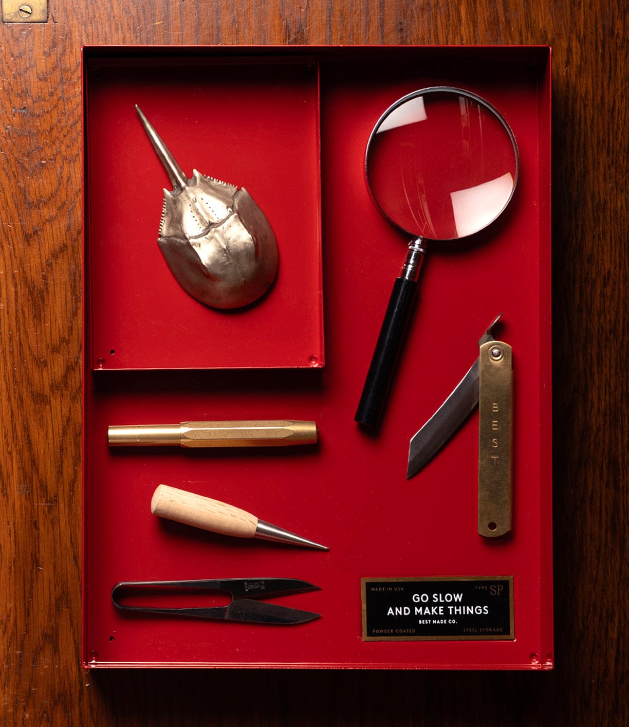 Collection of tools and items in a red box with 'Best Made Company' branding.