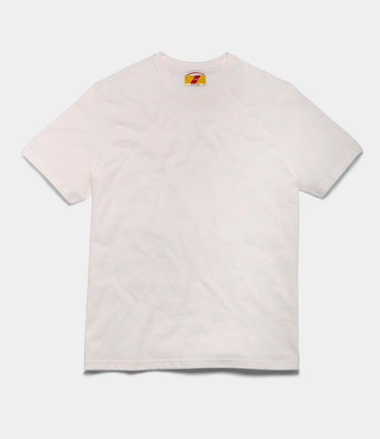 The Best Made Co. Standard T-Shirt Undyed, made from soft Peruvian tangüis cotton, is shown laid flat on a white background with a small colorful tag at the inside neckline.