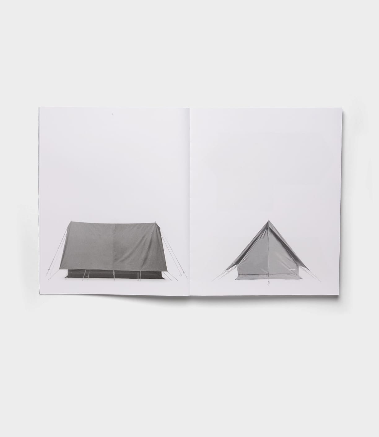 An open copy of Best Made Co.'s "The Camping Tent" shows black-and-white photos of a tent—a side view on the left and front view on the right—set against a plain white background in a minimalist, Robert Adams-inspired style.