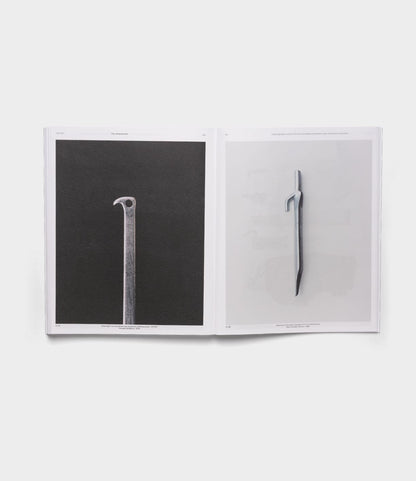 An open book displays The Camping Tent by Best Made Co., with two pages showing close-up photos of the tent against plain backgrounds—one dark, one light. The centered images recall Robert Adams’ handcrafted art style.