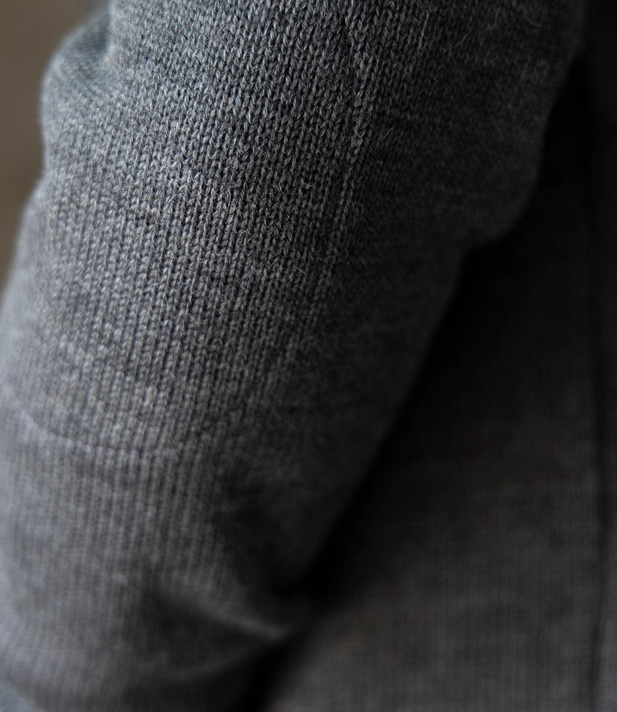 Close-up of the Dehen Shawl Neck Sweater in Charcoal by Best Made Co., featuring textured dark grey worsted wool knit with a visible weave and soft, fuzzy finish inspired by classic American workwear.