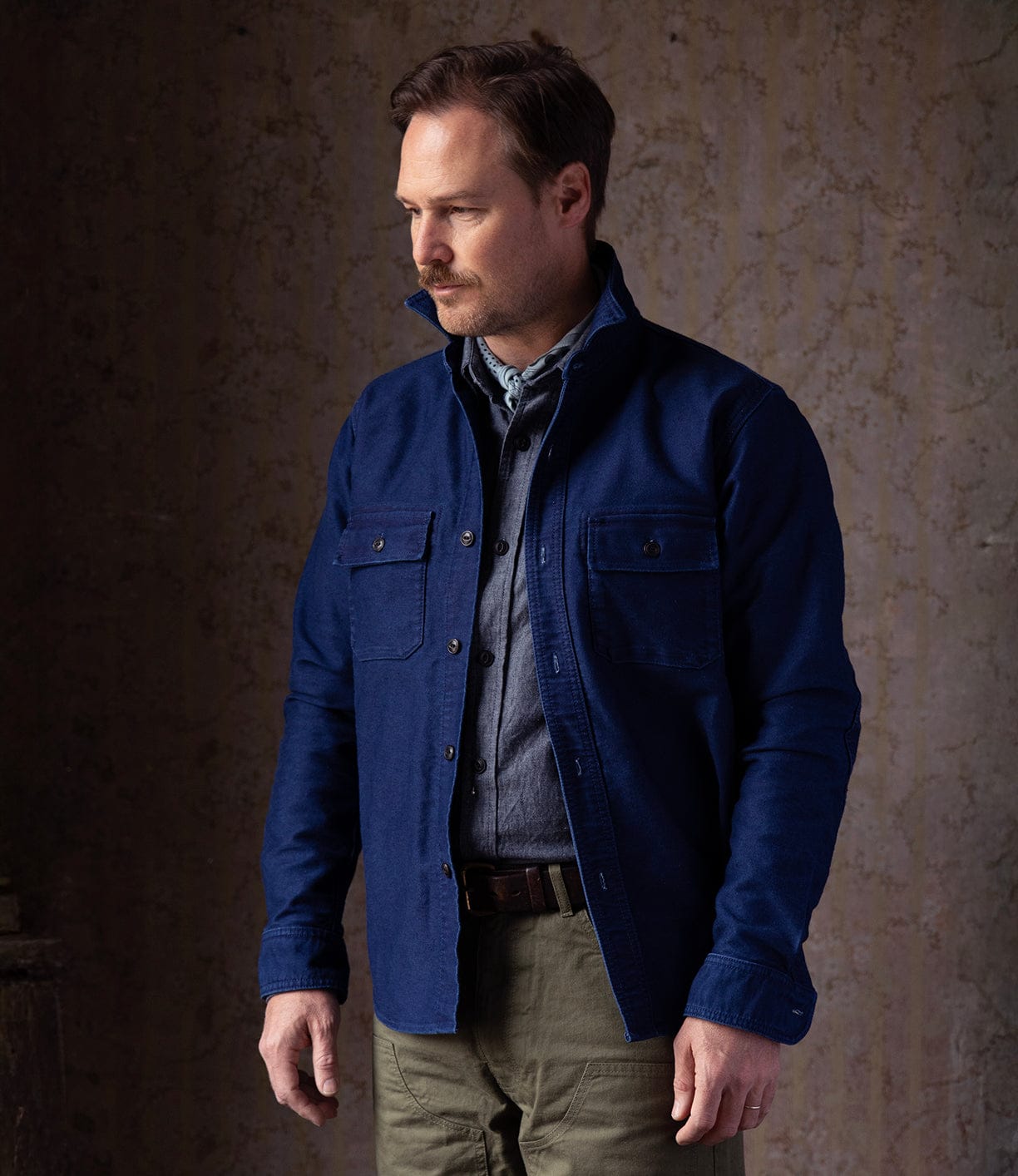 A man wears the Best Made Co Indigo Moleskine Work Shirt, crafted with high-density moleskin and triple-needle stitching.