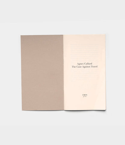 An open book displays the title page reading "The Case Against Travel" by Best Made Co., with ERIS and 2023 below. The left page shows a blank brownish cover, against a plain light gray background.