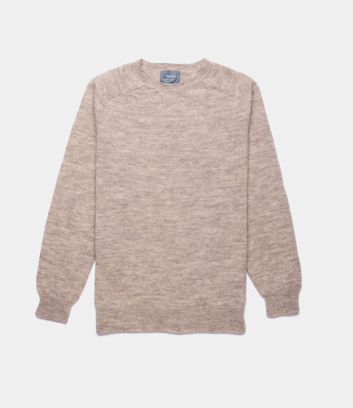 The 5-Gauge Shetland Sweater from Best Made Co. is a beige, long-sleeve crewneck featuring ribbed cuffs and hem, lightweight warmth, and seamless construction. Shown laid flat on a white background.