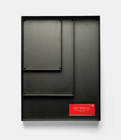 The Best Made Co. Spare Parts Trays (Set of 3) in matte black are metal wall organizers with three differently sized compartments, ideal for workbench organization, shown on a plain white background.