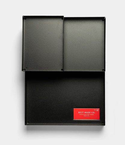 The Best Made Co. Spare Parts Trays (Set of 3) in matte black are rectangular metal organizers with three compartments, perfect for workbench organization; a red label reads "Best Made Co." on the bottom right compartment.