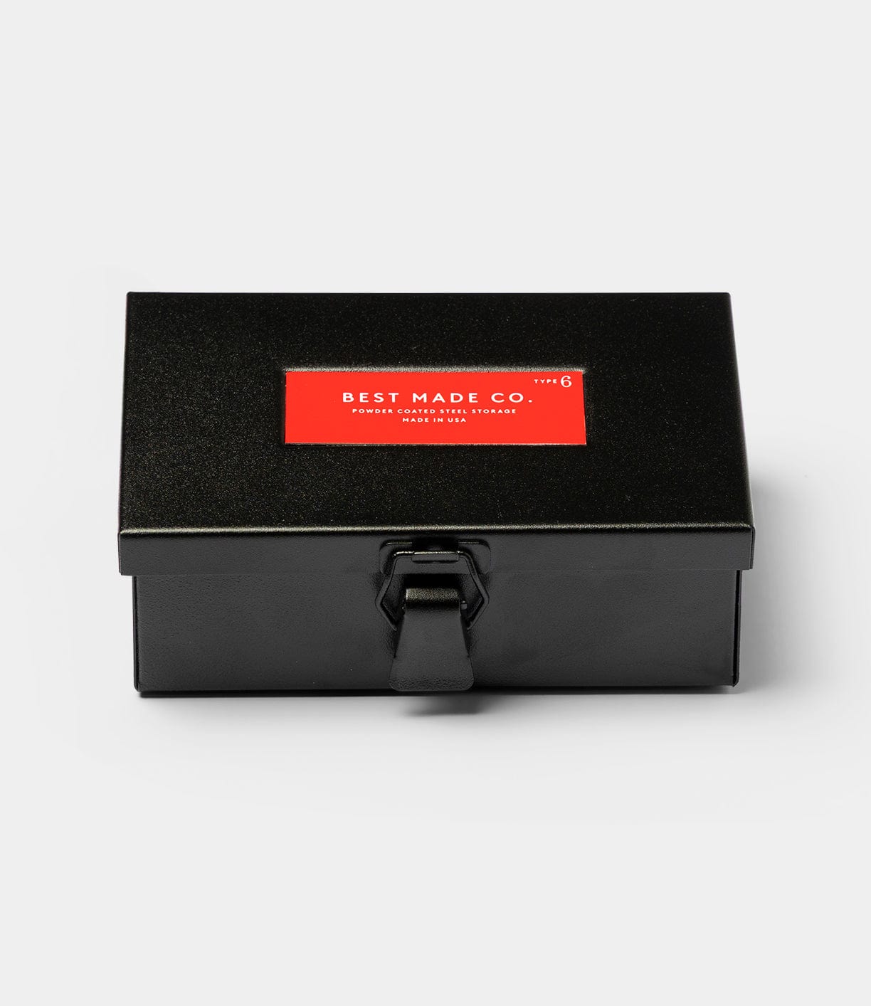 A black steel box with a latch closure and a red "Best Made Co." label on the lid, the Type 6 Strongbox, Go Slow Edition by Best Made Co., is photographed against a light gray background.