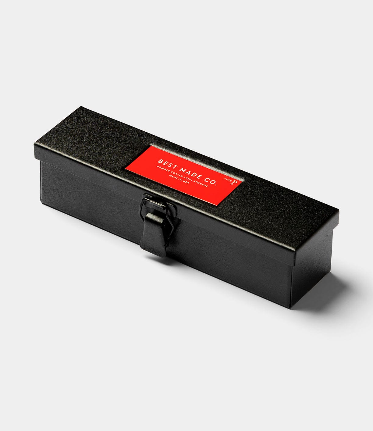 The Type P Strongbox, Go Slow Edition by Best Made Co is a rectangular black steel pencil storage box with a latch and a red BEST MADE CO label on top, shown against a plain light background.