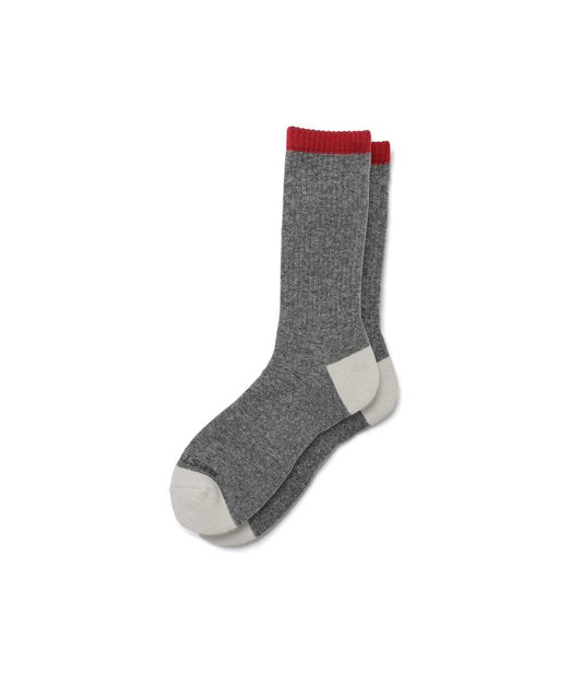 Three pairs of Standard Wool Socks by Best Made Co in red, gray, and blue with contrasting toes and heels. Made in the USA, these crew socks are ideal for everyday wear.