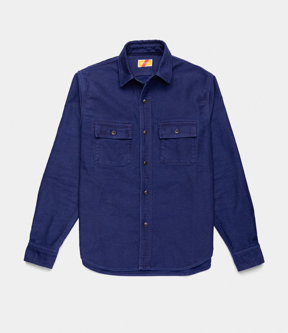The Best Made Co Indigo Moleskin Work Shirt is a long-sleeved, button-up Japanese indigo shirt in dark blue with two button-flap chest pockets, shown laid flat against a white background.