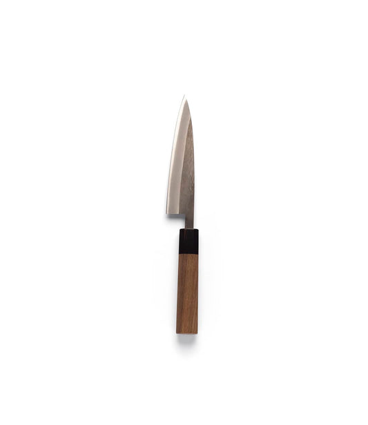 The Best Made Co. Aogami Petty is a small kitchen knife featuring a gleaming Aogami blue steel blade and a rectangular Shou Sugi Ban handle, shown against a simple light gray background—an elegant showcase of Japanese Chef Knives craftsmanship.