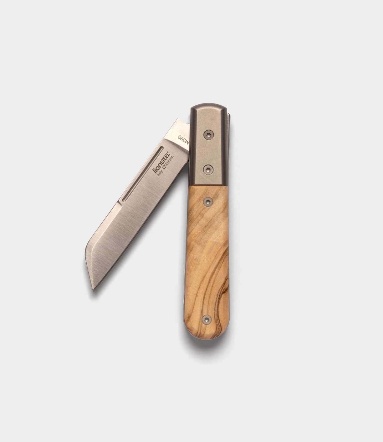 The Best Made Co. Italian Barlow is a folding pocket knife with a straight-edged M390 stainless steel blade and wooden handle, shown partially open against a plain light gray background. Inspired by the classic Barlow knife design.