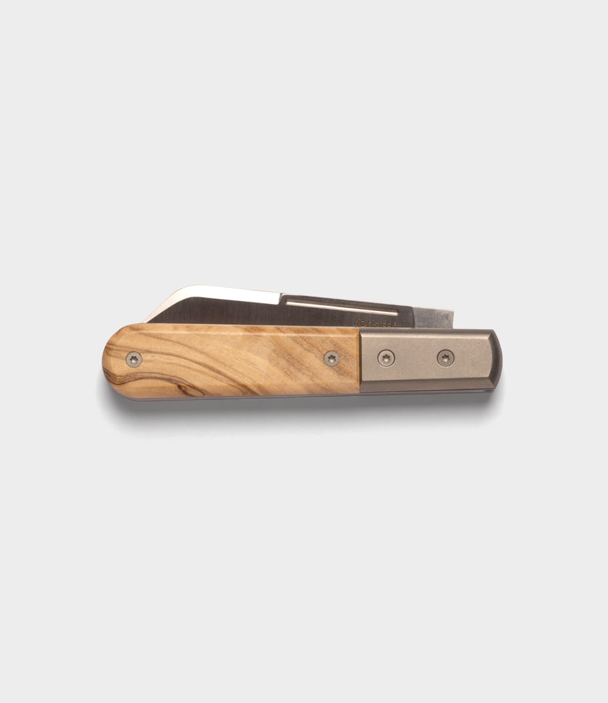 The Italian Barlow by Best Made Co., a folding knife with a wooden handle, metal accents, and premium M390 stainless steel blade, is displayed against a plain light gray background.