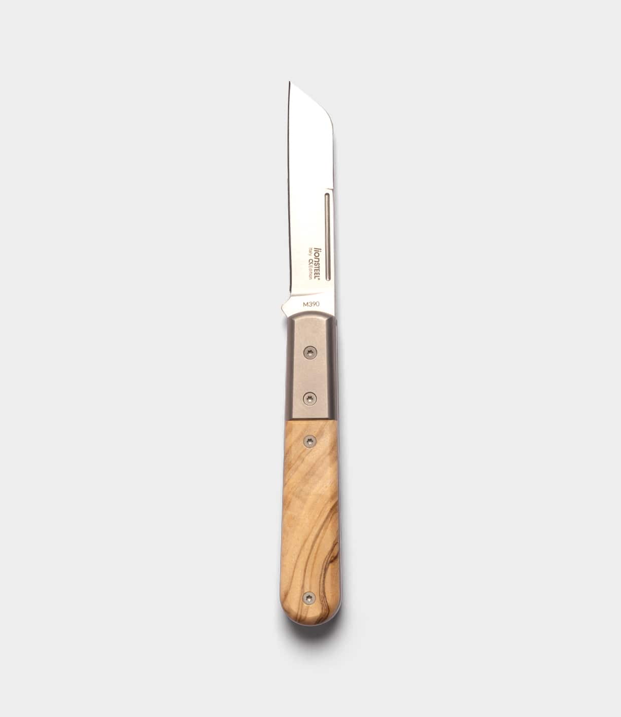 The Best Made Co. Italian Barlow showcases a straight-edged M390 stainless steel blade and light wood handle, pictured open on a plain, light gray background.
