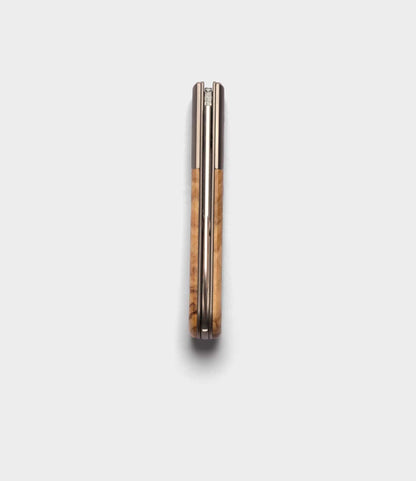 The Best Made Co. Italian Barlow knife, featuring an M390 stainless steel blade and wooden handle, is shown closed from above on a white background.