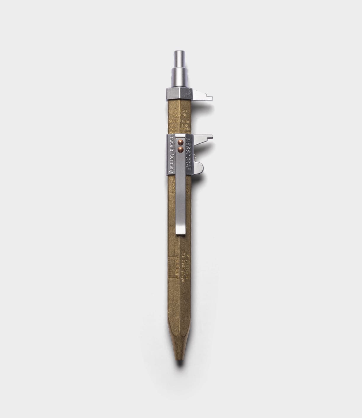 The Best Made Co. Brass Messograf Pen with a hexagonal brass body, metal clip, and exposed push button stands vertically on a plain white background.