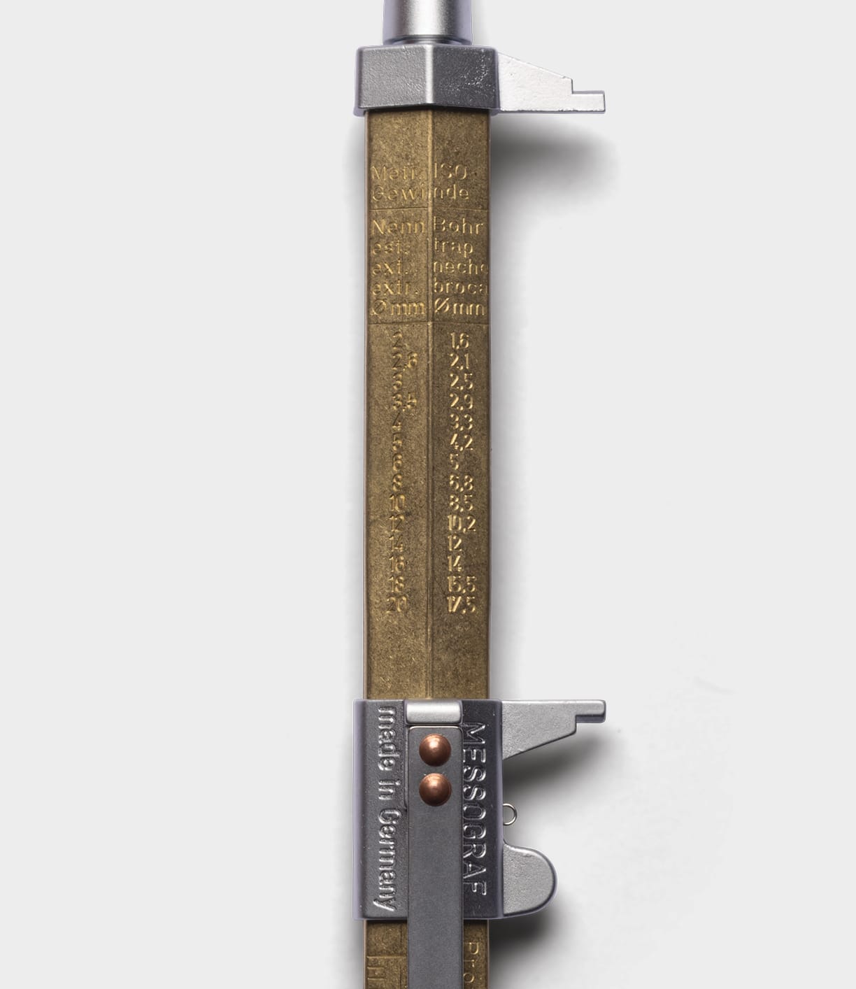 A close-up of a vintage-style Brass Messograf Pen by Best Made Co., featuring engraved measurement markings and a metal lock, set alongside a classic pen on a white background.