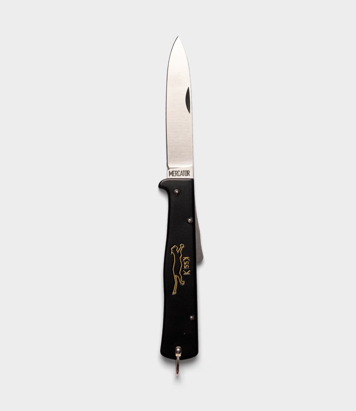 The Best Made Co. K55K Mercator folding knife features a silver blade, black handle, gold cat design, and "Mercator" near the hinge, shown on a plain light gray background.