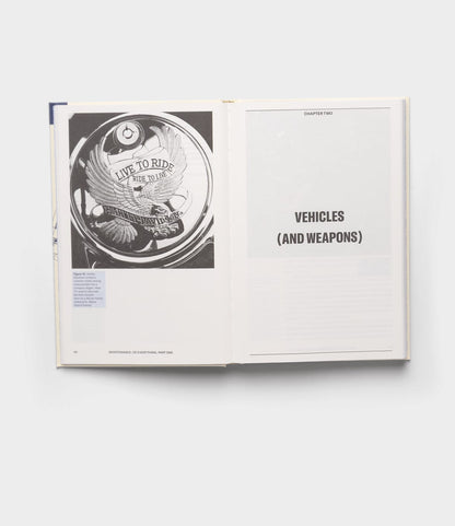 An open book from Best Made Co.'s "Maintenance of Everything" displays a black-and-white photo of a Harley-Davidson part engraved with "Live to Ride, Ride to Live," and a chapter titled "CHAPTER TWO VEHICLES (AND WEAPONS)," evoking maintenance themes.