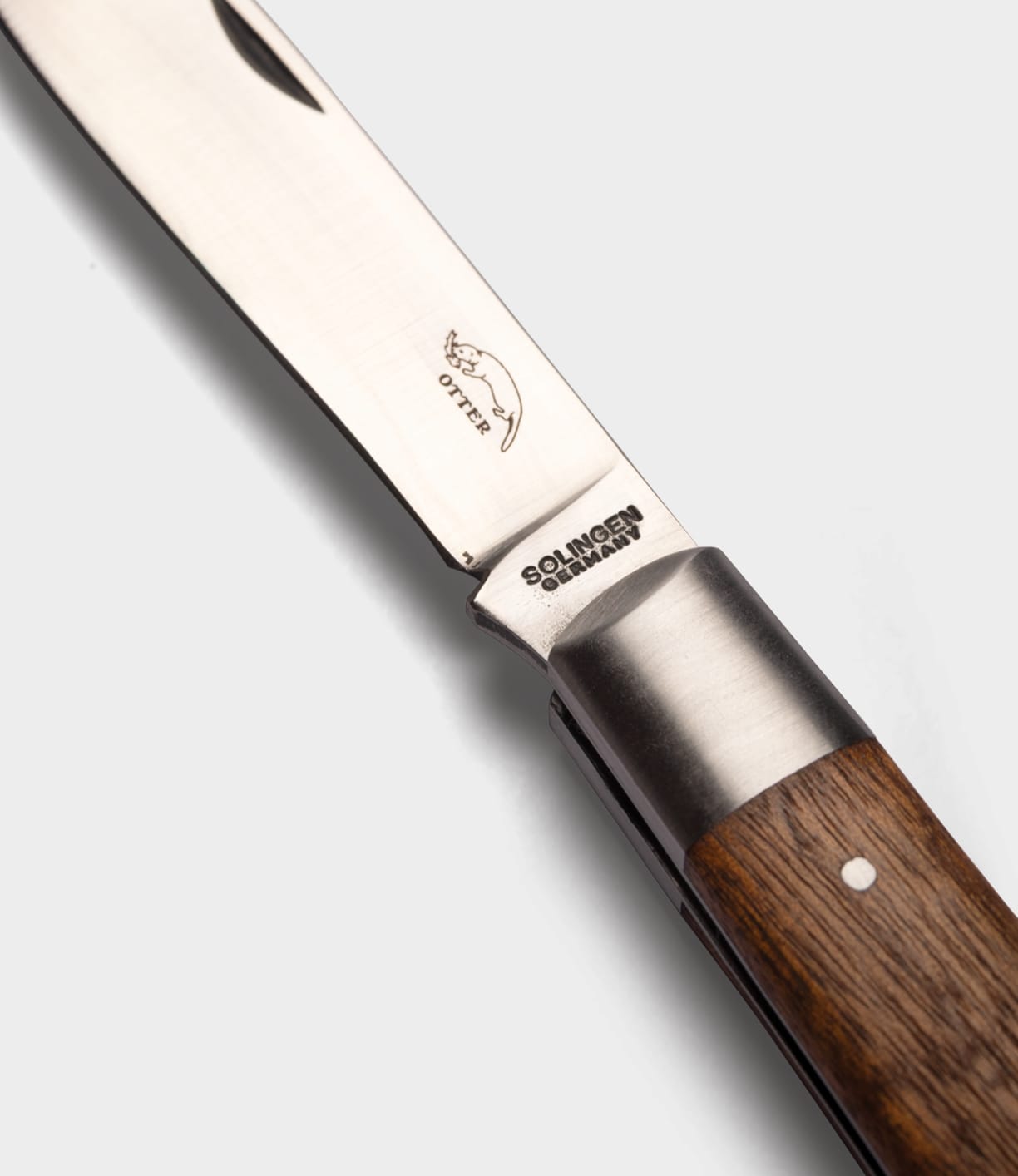 A close-up of the Best Made Co. Otter-Messer Pocket Knife, featuring a sapele handle, stainless steel blade engraved with an otter logo and "Solingen Germany.