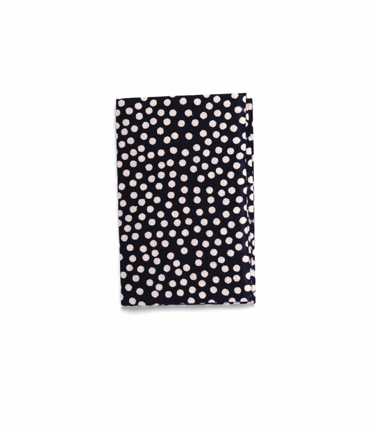 The Arare Tenugui by Best Made Co., a hand-dyed Japanese cloth with a black background and white polka dots crafted using the chusen technique, is shown folded on a plain light grey surface.