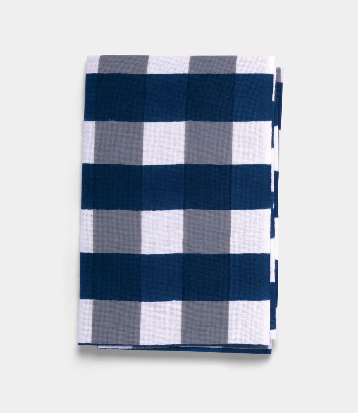 A folded Benkei-Jima Tenugui by Best Made Co., a hand-dyed Japanese cloth with large navy blue, gray, and white checkered squares, is displayed on a plain light background.
