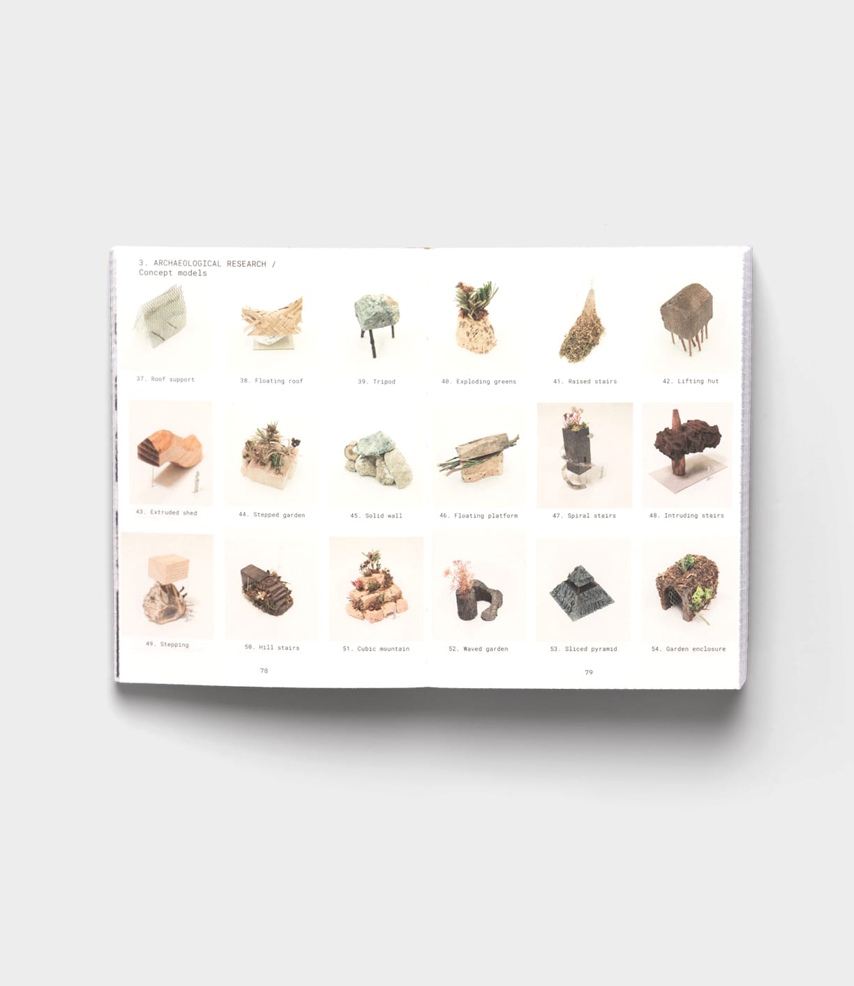 An open book shows a grid of 20 small architectural models, including Tane Garden House by Best Made Co., on a white background, reflecting the innovative spirit of sustainable architecture found in Vitra Design Museum exhibits.