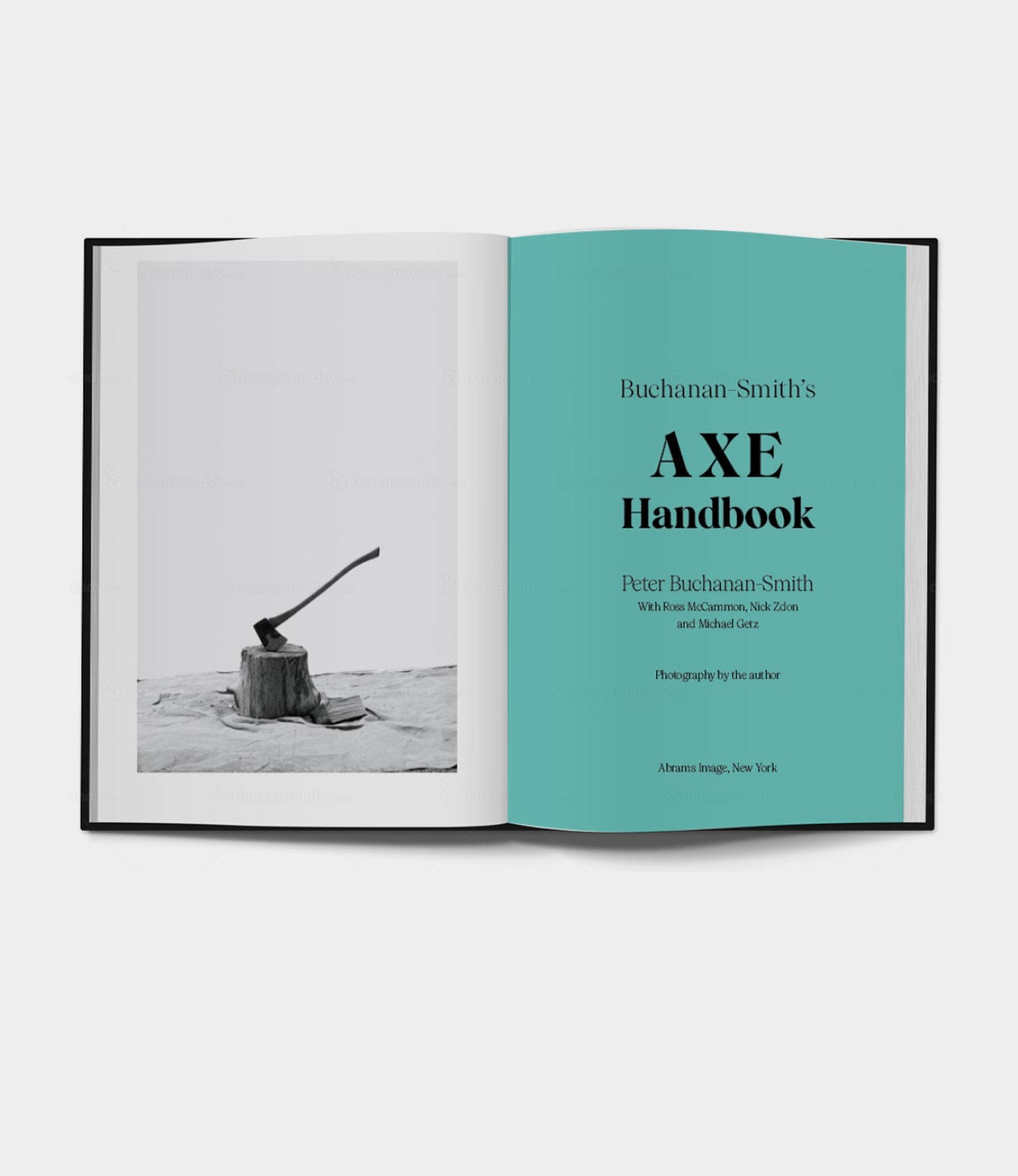 An open book shows a black-and-white photo of an axe in a stump on the left and the title page on the right, reading Buchanan-Smith’s Axe Handbook by Best Made Co.