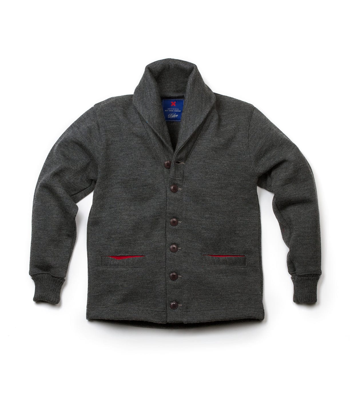 The Best Made Co. Dehen Shawl Neck Sweater Charcoal features a shawl collar, long sleeves, and two front pockets lined with red accents. The rugged sweater is displayed flat on a white background.