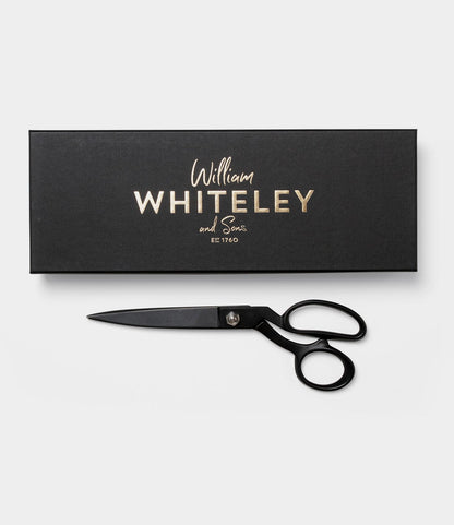 Kevlar Shears by Best Made Co. with a matte black finish are placed next to a black rectangular box featuring gold text on a plain white background.
